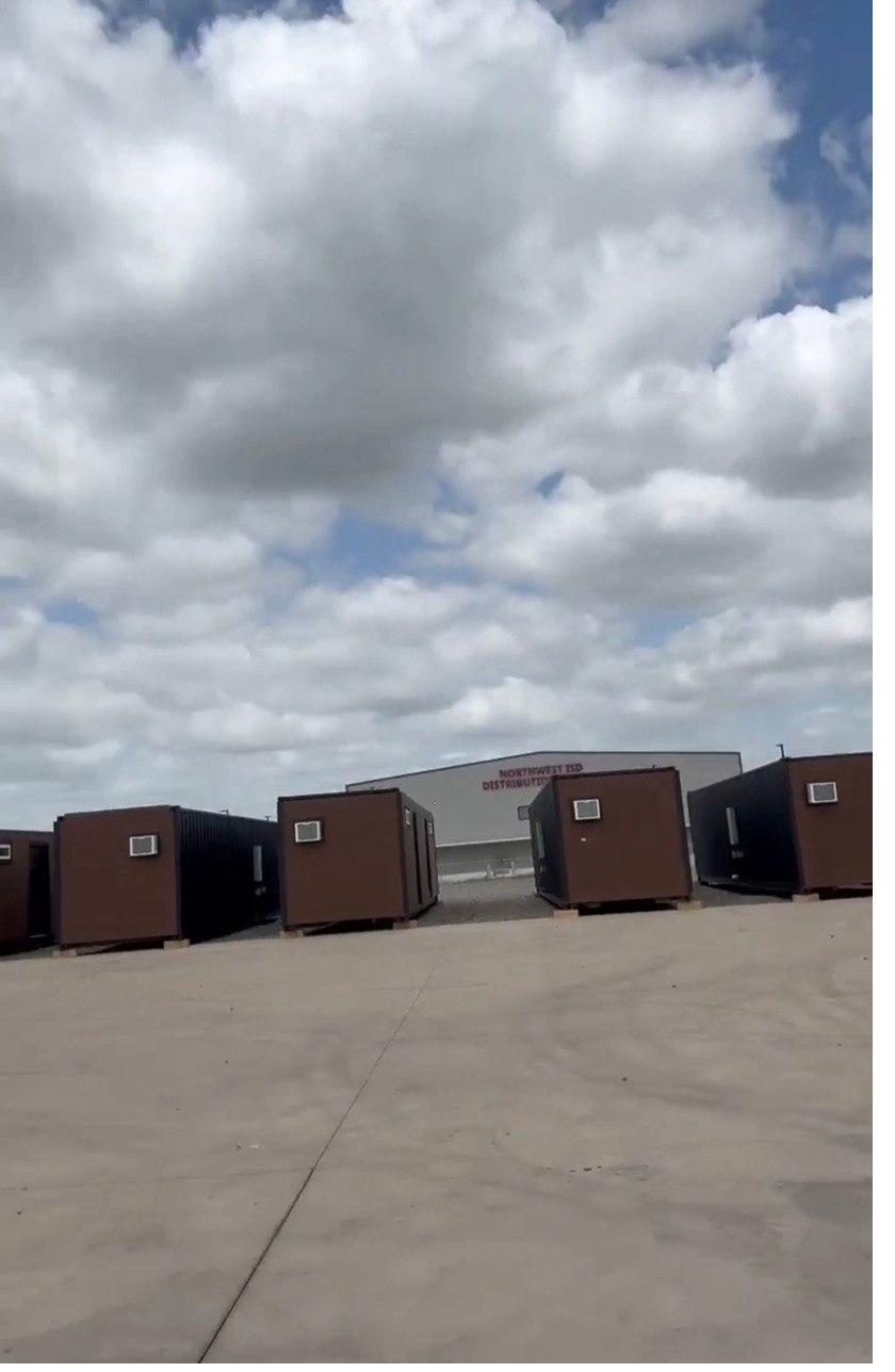 Row of finished HOME9 duplexes staged in a delivery lot